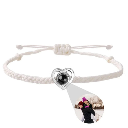 Bracelet with heart-shaped charm and photo pendant on a white background