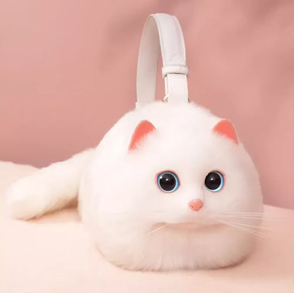 White cat-shaped plush toy purse with pink accents on a pink background
