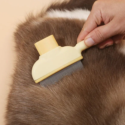 Person using a yellow pet grooming brush on a brown animal's fur.