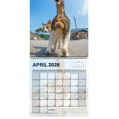 Calendar page for April 2026 with a cat and turtle on a beach