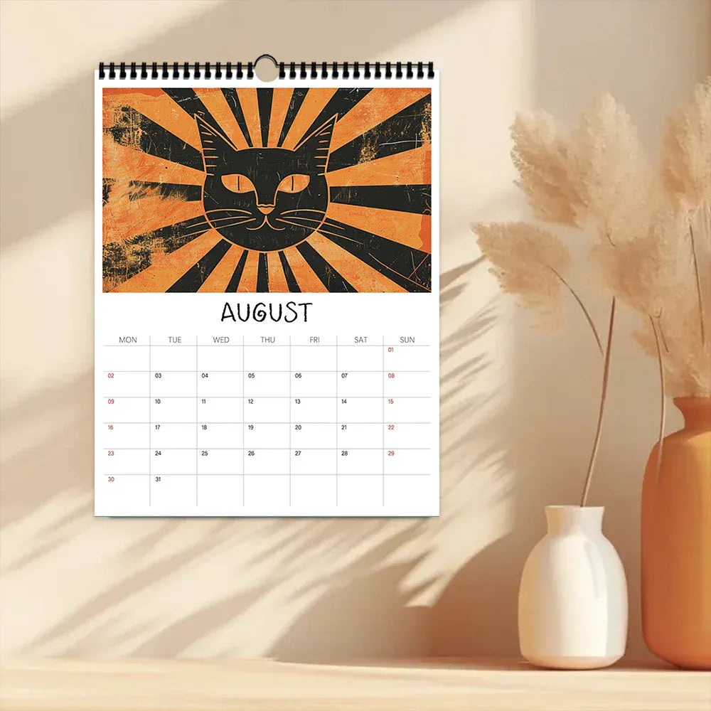 Calendar with a cat design for August on a wooden surface with decorative vases.