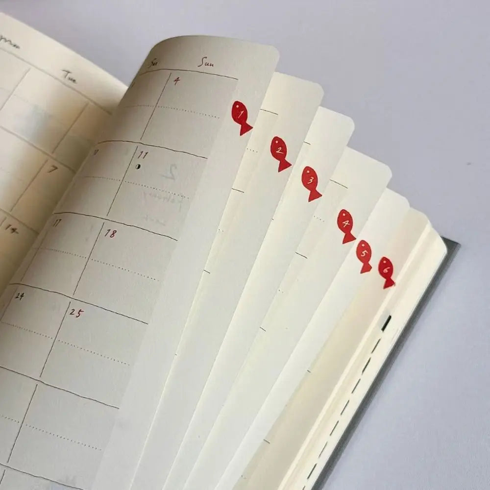 Calendar pages with red markers on a light gray background