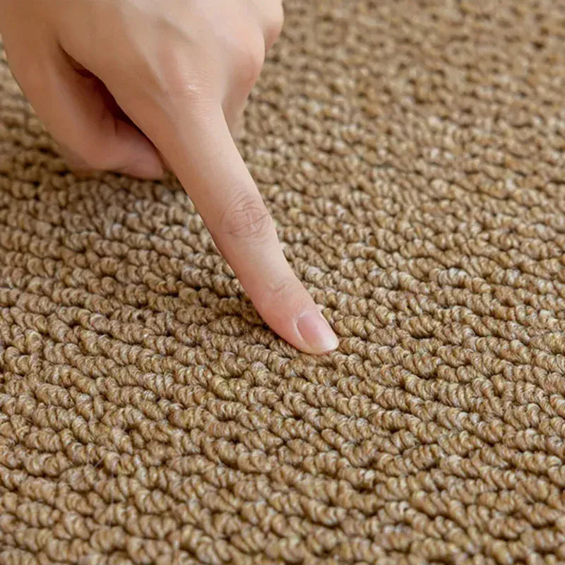 Hand pointing at a brown carpet texture