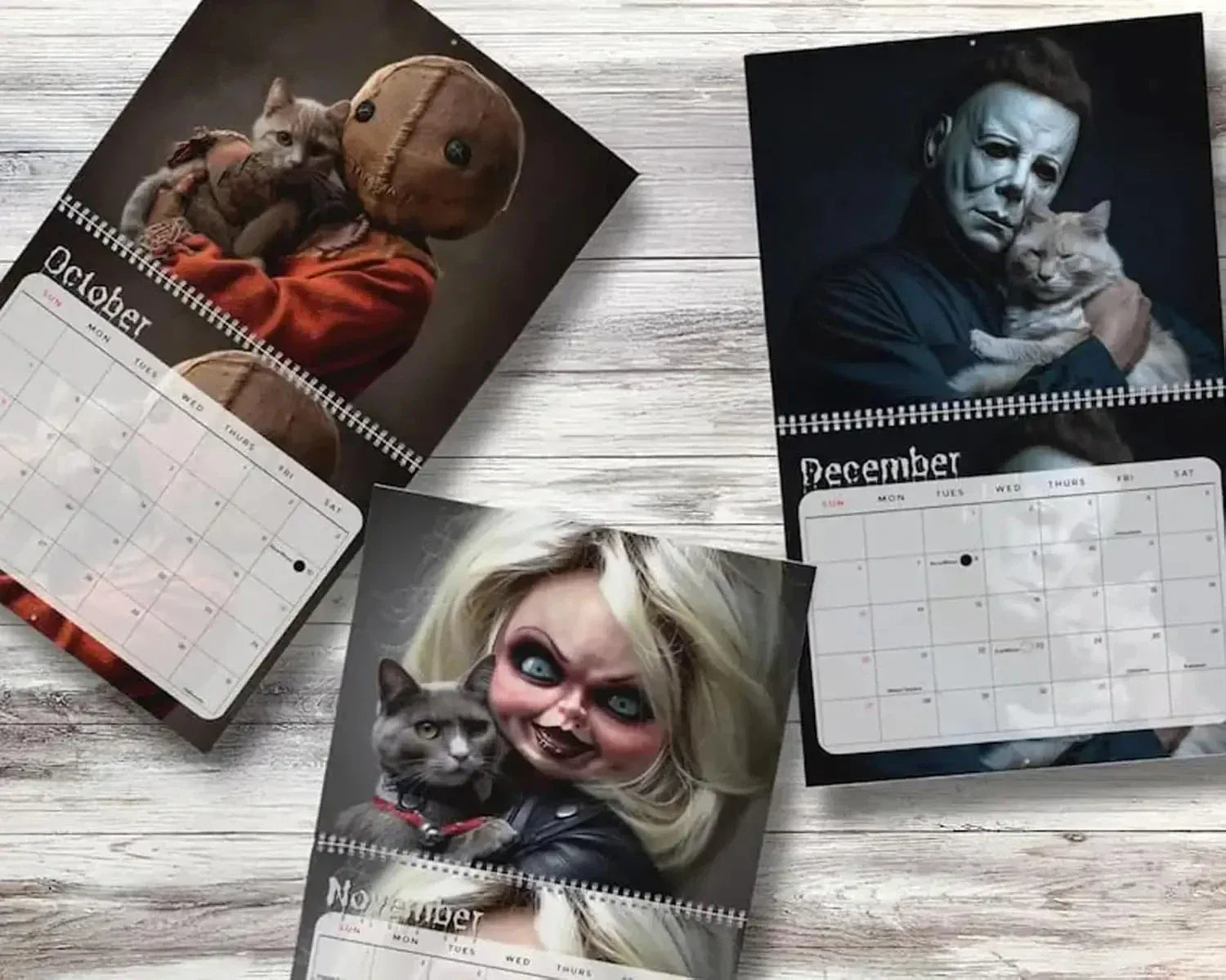 Three Halloween-themed calendars showing October, November, and December on a wooden surface.