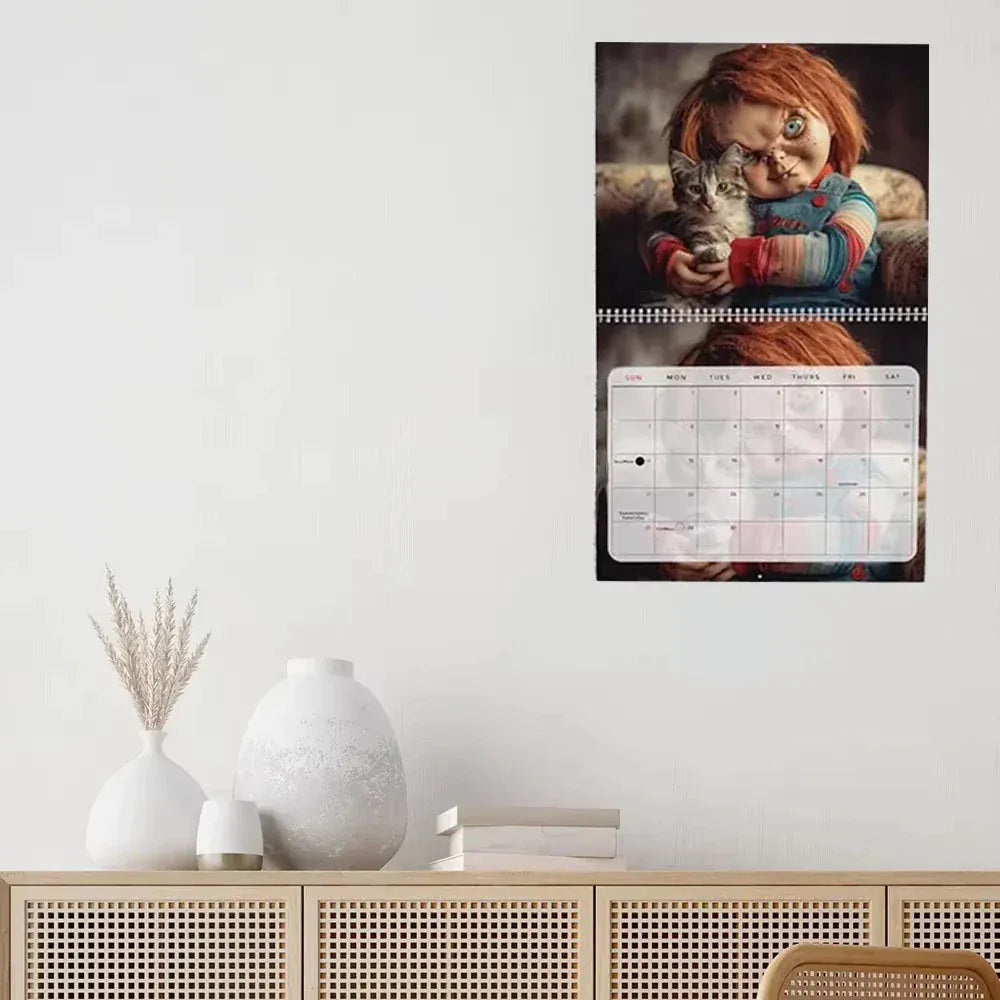 Calendar with a person holding a cat on a wall above a wooden cabinet.
