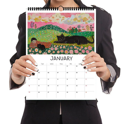 Person holding a calendar with a colorful illustration of a garden and black cat on a pink background.