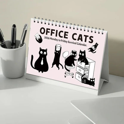 Desk calendar titled 'Office Cats' on a desk with office supplies.