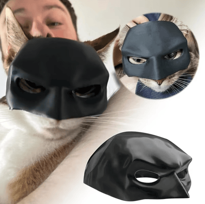 A black superhero mask designed for cats, with images showing the mask fitted on both a white and a black cat, as well as a human face for scale.