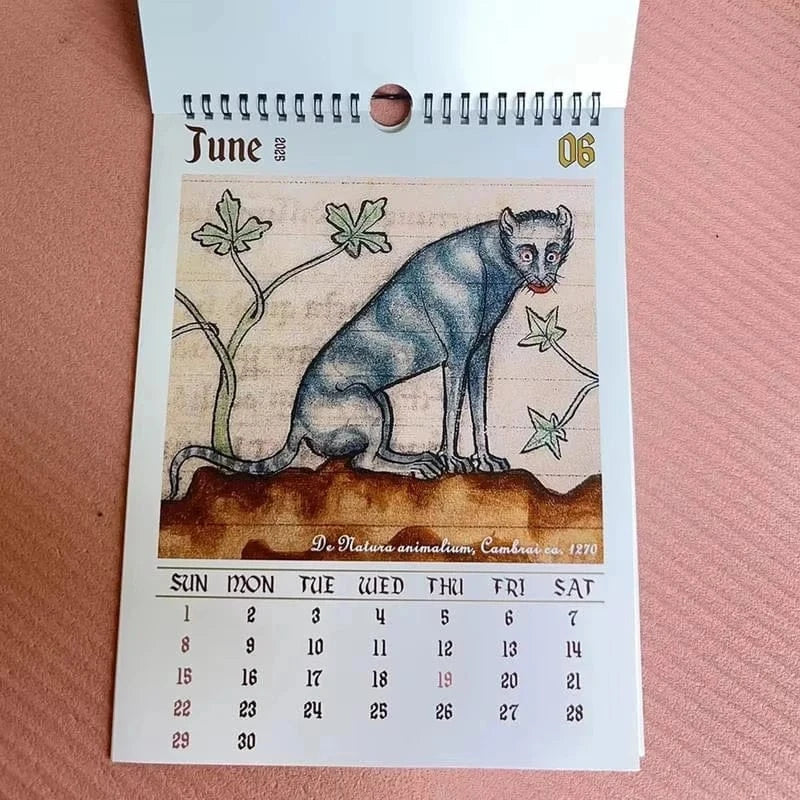 Calendar page for June with a blue creature illustration on a pink background