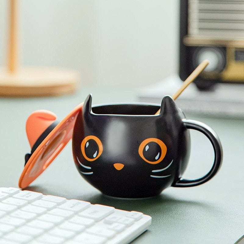 Black Cat Mug on Desk – Pumpkin Eyes & Witch Hat Detail