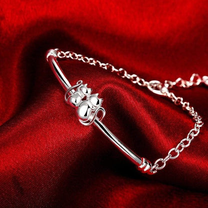 Sterling Silver Cat Paw Bracelet – Red Background Close-Up