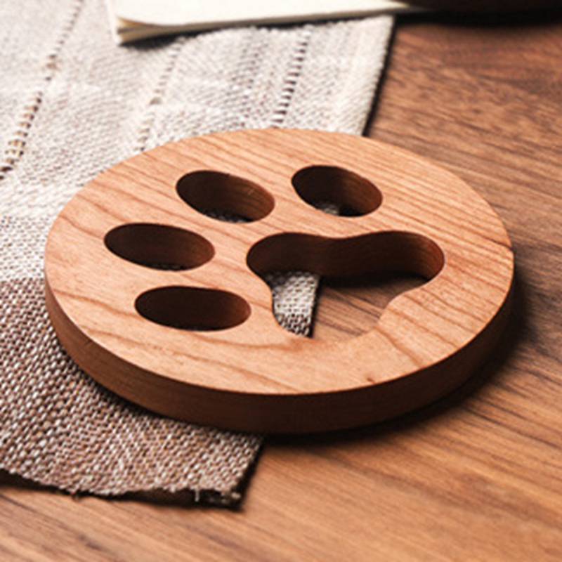 Non-skid wood coasters featuring paw prints for coffee